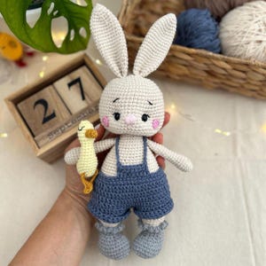 Handmade Crochet Bunny in Overalls with Duck. Amigurumi Plush Toy. Soft Stuffed Animal Gift for Baby Shower or Nursery Decor.
