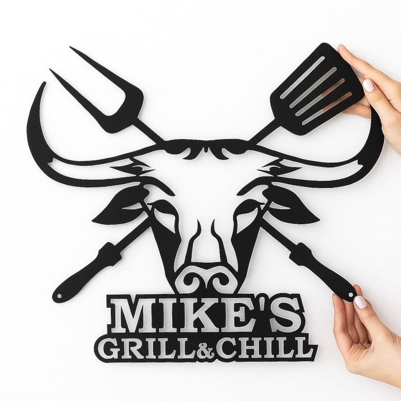 Custom metal BBQ name sign with bull head and grilling tools, personalized wall decor for outdoor kitchen.