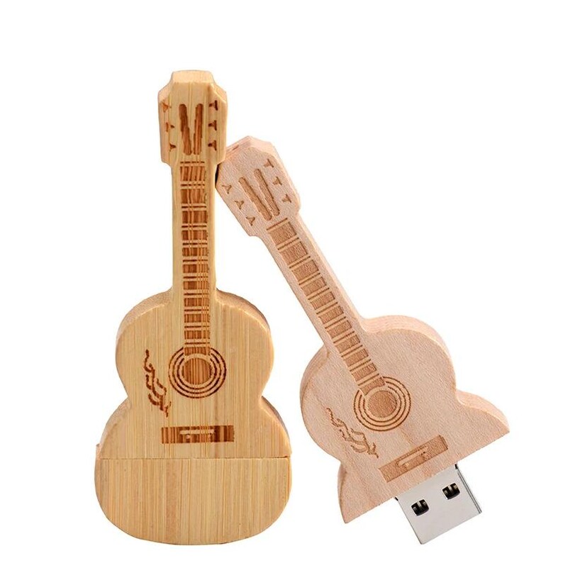 May include: Two wooden guitar shaped USB flash drives. One is light brown and the other is a darker brown. Both have a detailed guitar design.