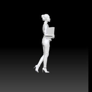 May include: A white 3D scale model of a person standing in profile, wearing a collared shirt, long trousers, and high-heeled shoes. The figure has hair tied in a bun and is holding a rectangular folder or book against the chest. The text IE_011 is visible.