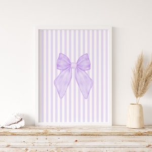 May include: A printable wall art design featuring a large purple bow on a background of alternating white and light purple vertical stripes.
