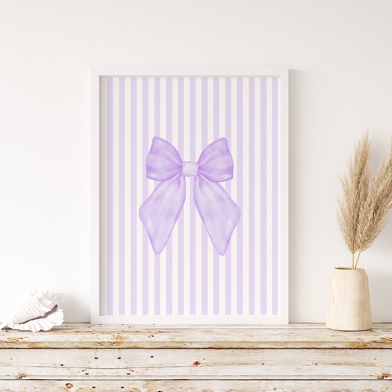 May include: A printable wall art design featuring a large purple bow on a background of alternating white and light purple vertical stripes.