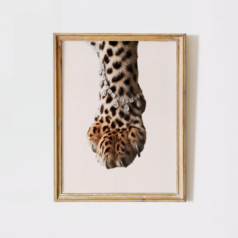 May include: A close-up of a leopard's paw with a diamond bracelet around the ankle. The paw is brown and black with spots and the bracelet is made of clear diamonds.