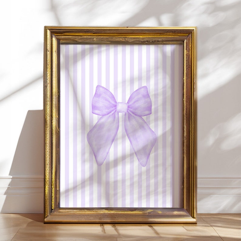 May include: A framed print with a purple bow on a white and purple striped background.