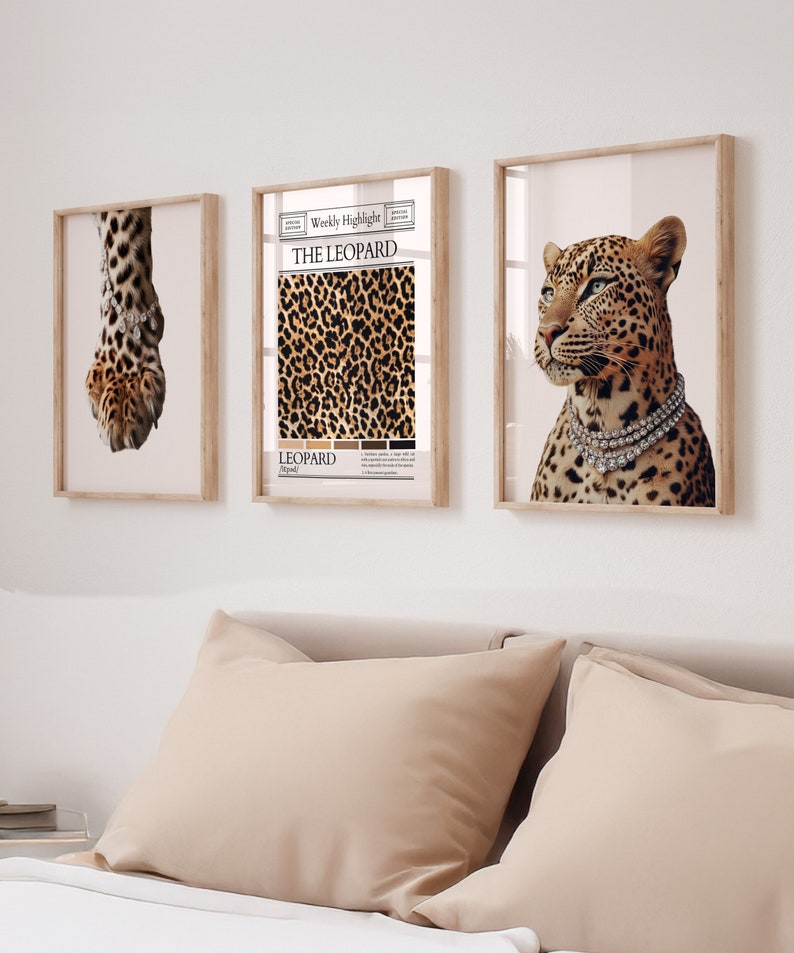 May include: Three framed prints with a leopard theme. The left print shows a close-up of a leopard's paw with a diamond bracelet. The middle print features a leopard print pattern with the text "The Leopard" and "Leopard" in a vintage newspaper style. The right print shows a leopard with a diamond necklace looking to the left.