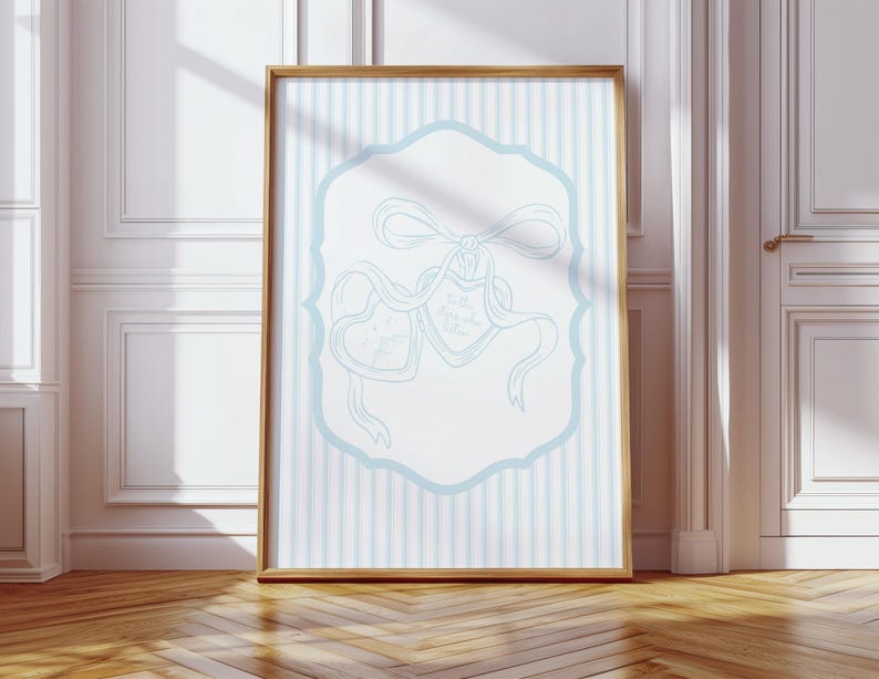 May include: A framed print with a light blue and white striped background. The print features a light blue decorative frame with two heart-shaped elements tied with ribbons. The text on the hearts reads "To the moon and back, forever."