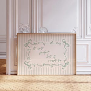 May include: A white ceramic mug with a black handle and the text "But First, Coffee" in a black, handwritten-style font. The mug is on a white surface.