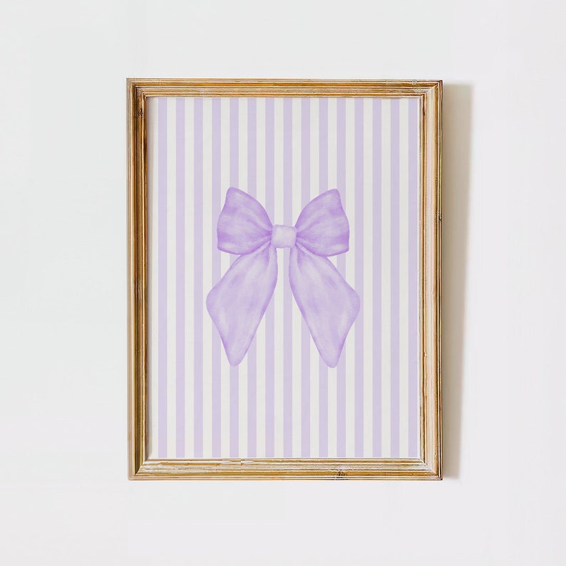 May include: A framed print with a purple bow on a white and purple striped background.