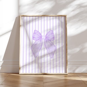 May include: A printable digital download featuring a watercolor illustration of a large purple bow on a background of alternating white and light purple vertical stripes.