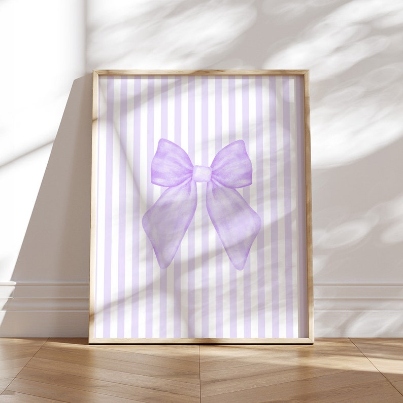 May include: A printable digital download featuring a watercolor illustration of a large purple bow on a background of alternating white and light purple vertical stripes.