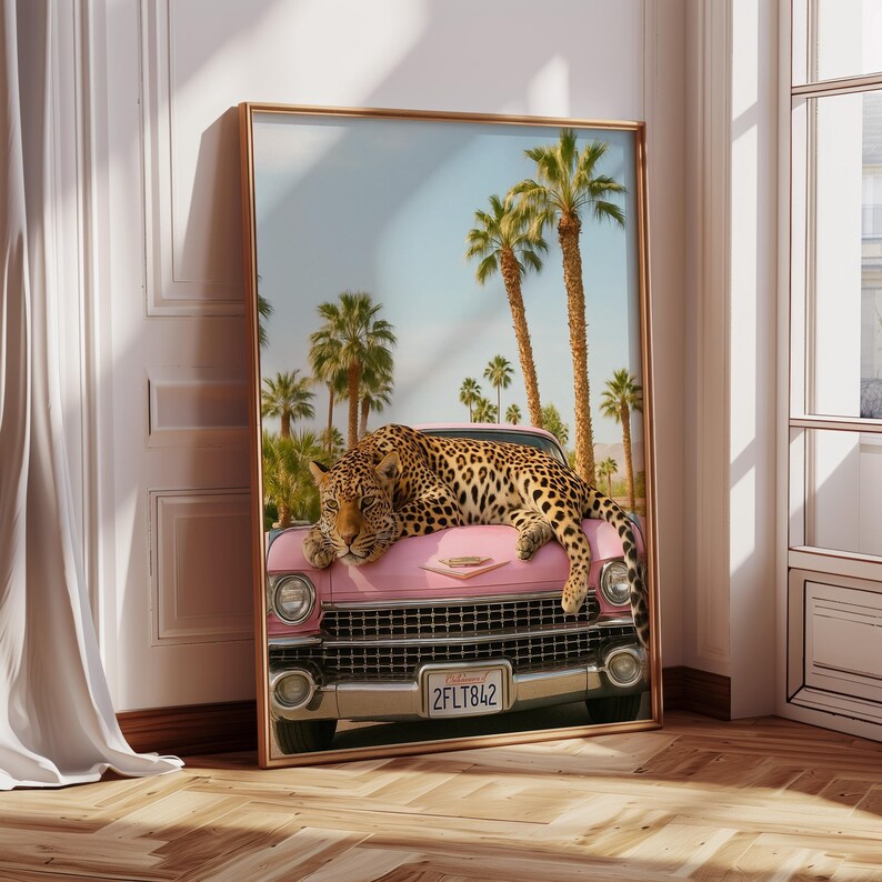 May include: A pink vintage car with a leopard lying on the bonnet. The car has a California number plate that reads "2FLT842". The car is parked in front of a row of palm trees.
