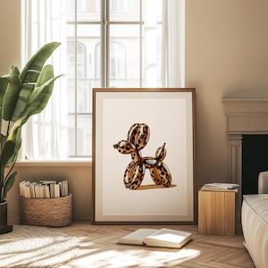 May include: A framed print of a leopard print balloon animal shaped like a dog. The balloon animal is standing on a white background.