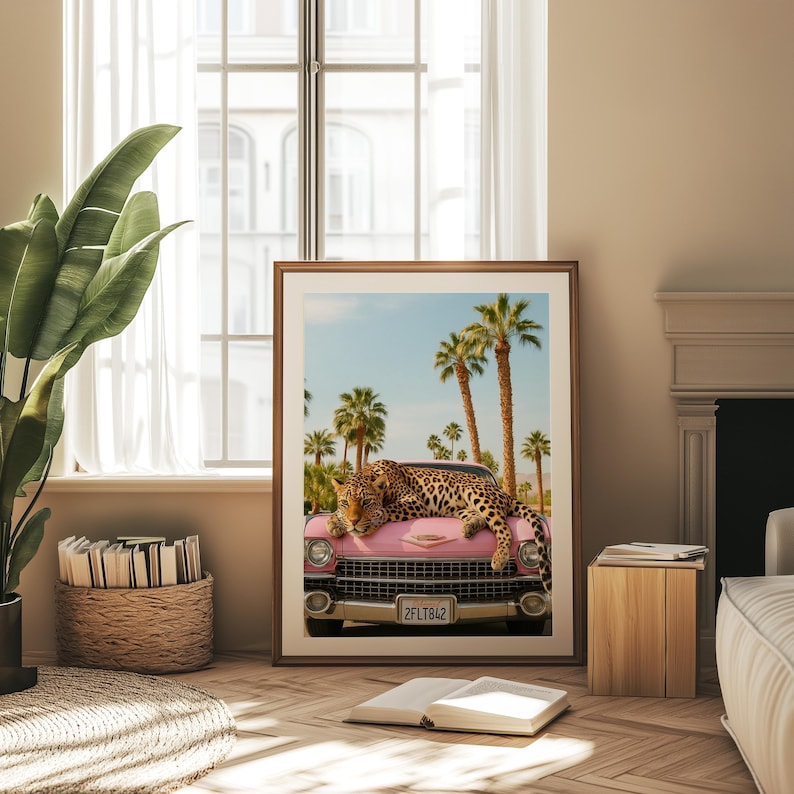 May include: A pink vintage car with a leopard lying on the bonnet. The car has a number plate that reads "2FLT842". The car is parked in front of a palm tree lined street.
