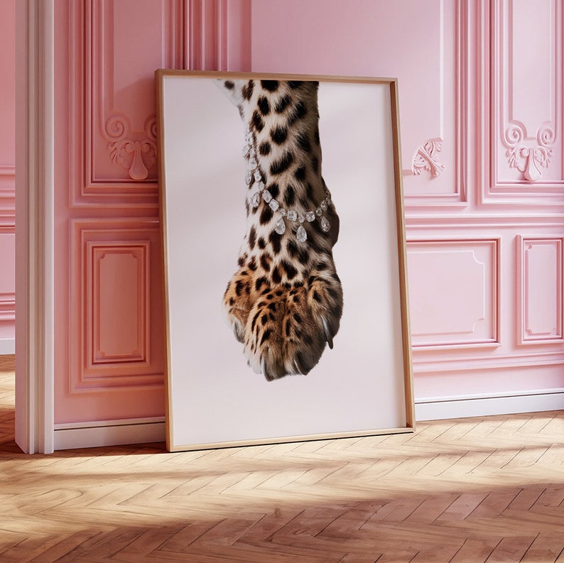 May include: A close-up of a leopard's paw with a diamond bracelet around the ankle. The paw is brown and black with a spotted pattern. The diamonds are clear and sparkle.
