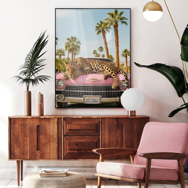 May include: A pink vintage car with a leopard lying on the bonnet. The car is parked in front of palm trees and a blue sky. The number plate reads "2FLT842".