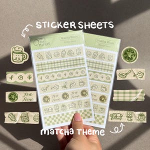 May include: Two clear plastic sleeves containing Matcha Washi sticker sheets with a green and cream color palette. The sheets feature various patterns including plaid, checkered, floral, and tea-themed illustrations with the text Tea Time.