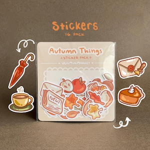 May include: A 16-pack of stickers titled "Autumn Things" featuring fall-themed illustrations. The stickers include images of apples, leaves, a coffee cup, an umbrella, and a slice of pumpkin pie. The stickers are in a clear plastic package.