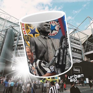 May include: A white ceramic mug with a colorful design featuring a soccer player, a statue of a man, and a soccer team logo. The mug has the words "Newcastle Brown Ale" and "The Terrace Bar" printed on it.