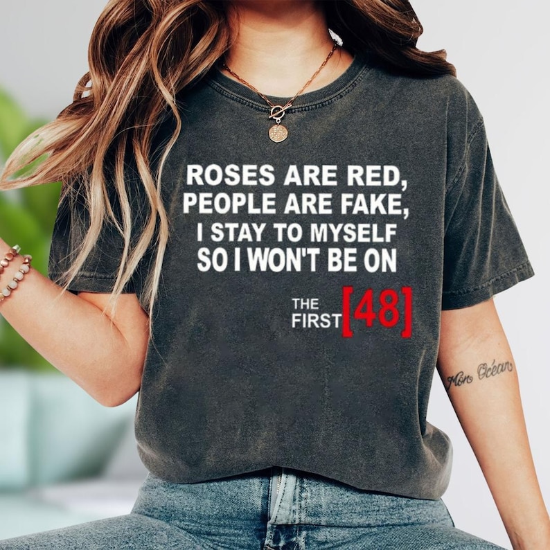 A person wearing a black t-shirt with text printed on it.