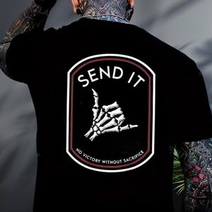 a man with a tattoo on his arm wearing a black shirt