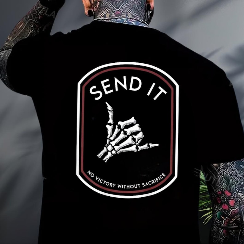 a man with a tattoo on his arm wearing a black shirt
