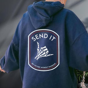 a person wearing a hoodie with the words send it on it