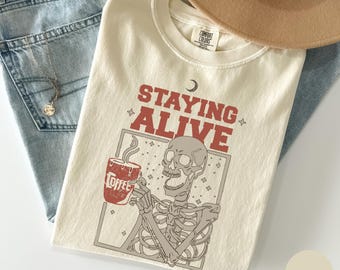 Comfort Colors Staying Alive Skeleton Coffee Shirt, Funny Skull Tee, Trendy Coffee Lovers Gift, Skeleton Drinking Coffee Shirt, Retro Shirt