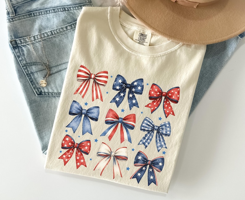 Comfort Colors patriotic bow shirt featuring red white and blue coquette bows for Fourth of July celebrations