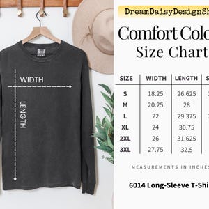 a black long-sleeve t-shirt hanging on a wooden hanger, along with a size chart and measurements for the shirt.
