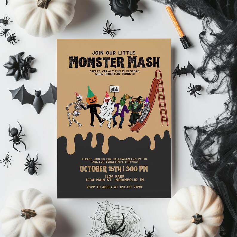 A laptop on a wooden desk with a small succulent plant and a white mug. The screen shows a Monster Mash invitation.
