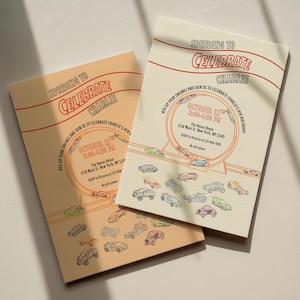 May include: Two birthday party invitations with a race car theme. The invitations are cream-colored with orange and red text that reads "Speeding to Celebrate Charlie." The invitations include the date, time, and location of the party.