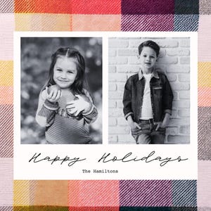 May include: A black and white photo Christmas card featuring two children. The girl is holding an apple and the boy is standing with his hands in his pockets. The card has the text "Happy Holidays" and "The Hamiltons" printed on it.