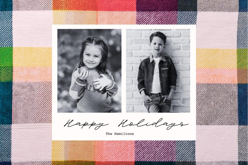 May include: A black and white photo Christmas card featuring two children. The girl is holding an apple and the boy is standing with his hands in his pockets. The card has the text "Happy Holidays" and "The Hamiltons" printed on it.