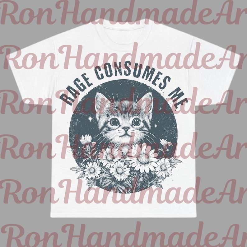 May include: White t-shirt featuring a distressed graphic of a kitten surrounded by flowers, with the text "RAGE CONSUMES ME" in a circular design. The design is in shades of gray, white, and black.