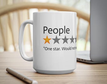 May include: White ceramic coffee mug with a black and gray one-star rating and the text "People" and "One star. Would not recommend."
