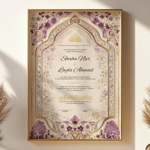 May include: Framed wedding certificate with gold trim, featuring floral and ornate design elements in purple and gold. The names "Shaha Nur" and "Layla Ahmad" are prominently displayed. The certificate is displayed on a white wall with decorative plants.