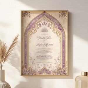 May include: A framed wedding invitation with a gold border. The invitation features a decorative arch design in shades of purple and gold, with floral accents. The names "Shaha Nur & Layla Ahmad" are displayed prominently.