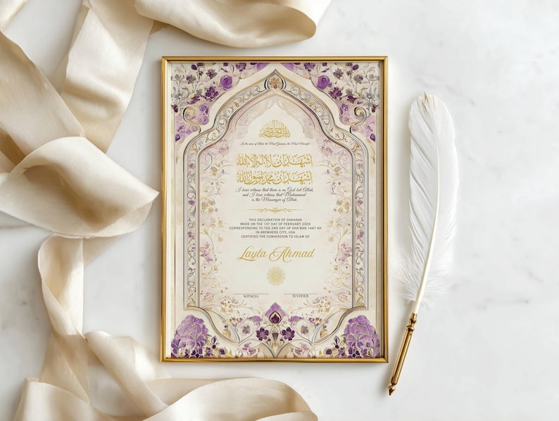 May include: A framed marriage certificate with gold detailing and floral patterns in purple and cream. The certificate features Arabic calligraphy and the name "Layla Ahmad". A white feather with a gold base is placed beside the frame.