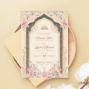 May include: An invitation card with floral and ornamental design. The card features the names "Shaha Nur" and "Layla Ahmad" with the date "December 30". The card is placed on a wooden plate with a cream-colored envelope.