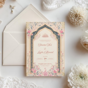 May include: Wedding invitation with floral and arch design. The invitation features the names "Shaka Nur & Layla Ahmad" and the date "30 December". The design includes pink and blue floral accents and is set against a cream background.