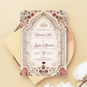 Puede incluir: Una invitaci&oacute;n de boda ornamentada con un fondo crema, con dise&ntilde;os florales y geom&eacute;tricos en rojo y dorado. La invitaci&oacute;n incluye los nombres "Shaha Nur" y "Layla Ahmad", junto con la fecha y el lugar de la ceremonia.