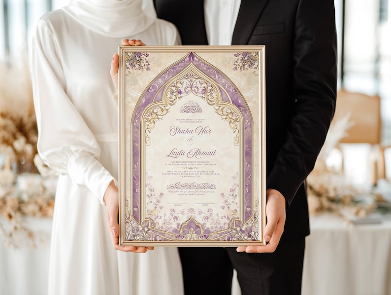 May include: A framed wedding certificate with a gold border and ornate purple floral design. The certificate features the names "Shaha War" and "Layla Ahmad" in elegant script. The couple holds the framed certificate.