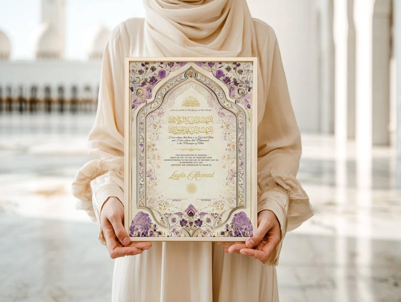 May include: A framed certificate with intricate floral and geometric patterns in purple and gold. The certificate includes Arabic calligraphy and the name "Layla Ahmad". The frame is a light beige colour.