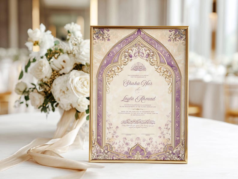 May include: A framed wedding invitation with ornate purple and gold detailing. The invitation features the names "Shaha Nur" and "Layla Ahmad" in elegant script. A bouquet of white flowers with a cream ribbon is in the background.