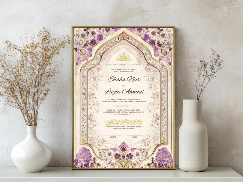 May include: A framed marriage certificate with a gold border, featuring floral and geometric designs in purple and gold. The names "Shaha Nur" and "Layla Ahmad" are displayed prominently. The certificate is displayed on a white shelf.