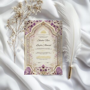 May include: An ornate wedding invitation with the names Shaha Nur and Layla Ahmad, featuring a floral design in purple and gold. The invitation is set against a white background with a feather and dried flowers.