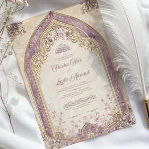 May include: An ornate wedding invitation with a beige background and a purple and gold decorative border. The invitation features the names "Shaha Nur & Layla Ahmad" in elegant script. The invitation is placed on a white surface with a feather and floral accents.