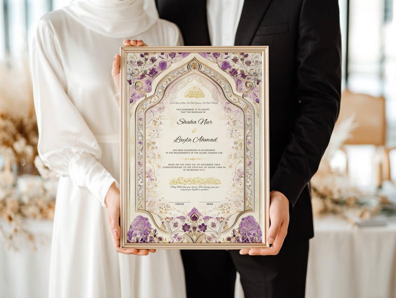 May include: A framed wedding certificate with a gold border. The certificate features ornate floral designs in purple and gold, with the names "Shaha Nur" and "Layla Ahmad" prominently displayed. The couple is holding the framed certificate.