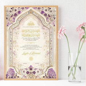 May include: A framed certificate with floral and geometric patterns in purple, gold, and cream. The certificate features Arabic script and the name "Layla Ahmad". A vase of pink flowers is to the right.
