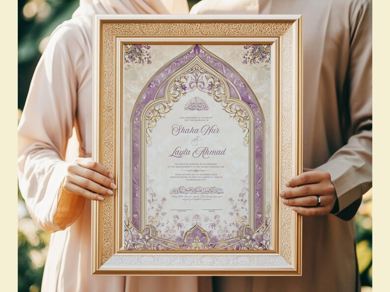 May include: Framed wedding invitation with a gold border, featuring a central design in shades of purple and cream. The invitation includes the names "Shaha Hur & Layla Ahmad" in elegant script, with decorative floral elements.